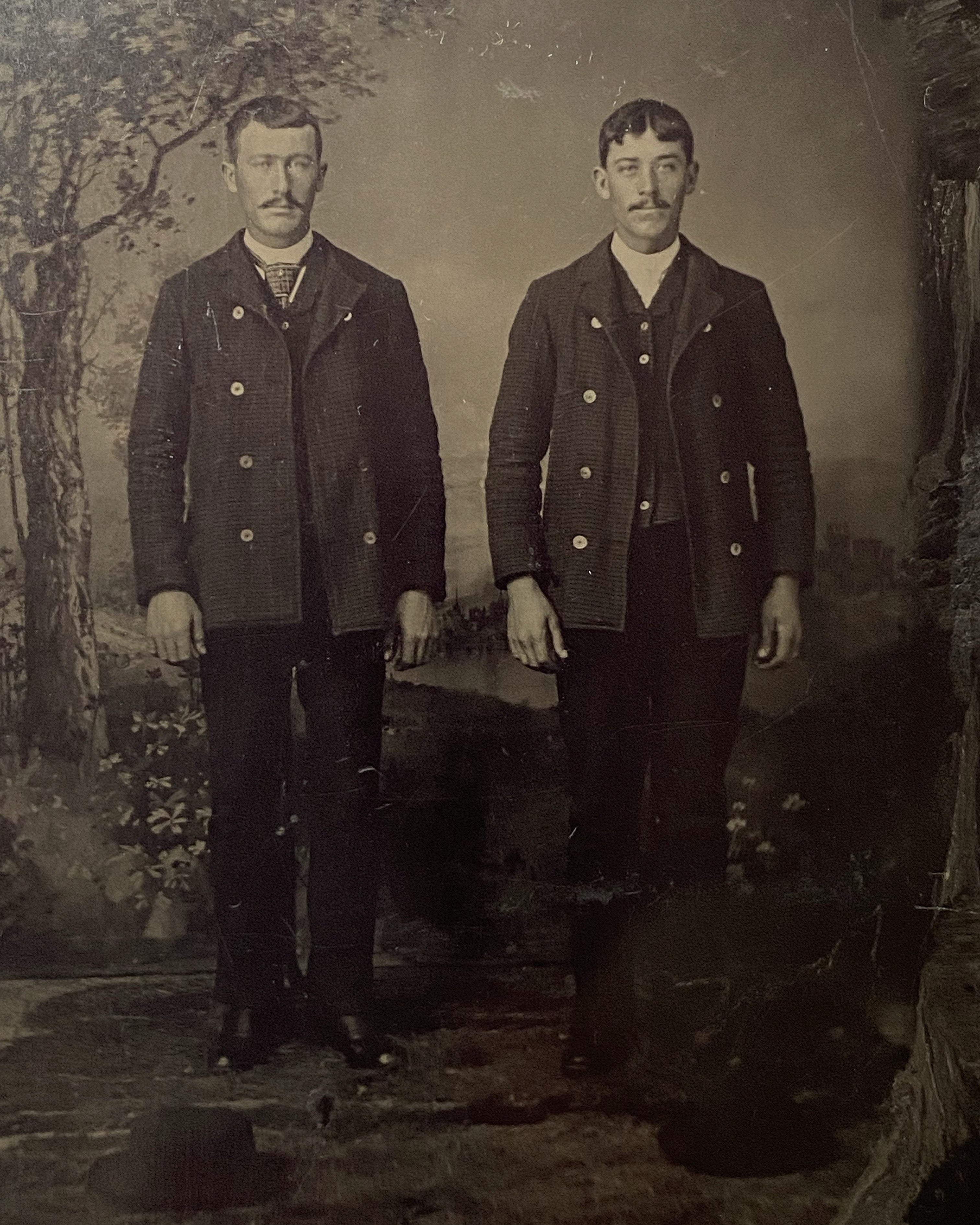 Two Men Twinning with Hats on Ground Tintype
