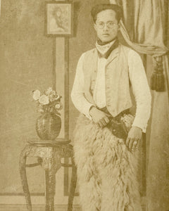 Asian Cowboy with glasses and vest holding rifle