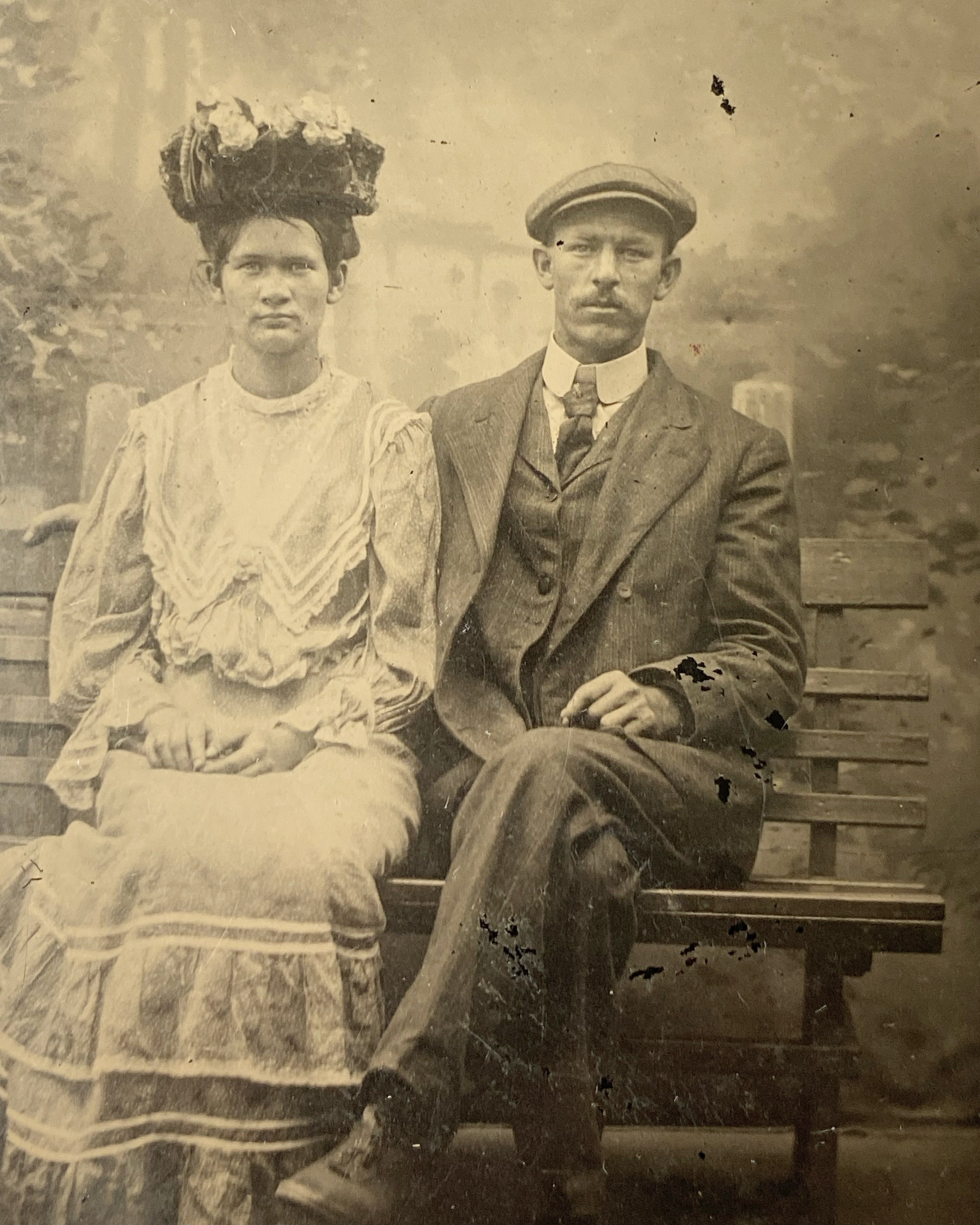 Couple Sitting on Bench with Unusual Hat on Woman Tintype